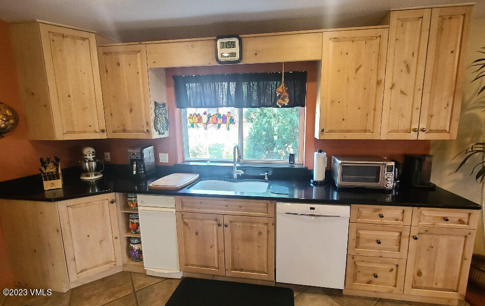 1072 Mesa Drive Eagle, CO 81631 - Photo 7 of 34 a kitchen with stainless steel appliances granite countertop a stove a sink and a microwave