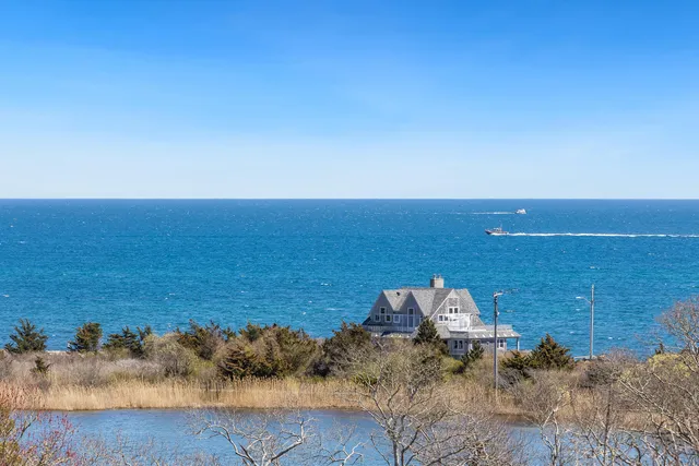 a living room with furniture a flat screen tv and a large window