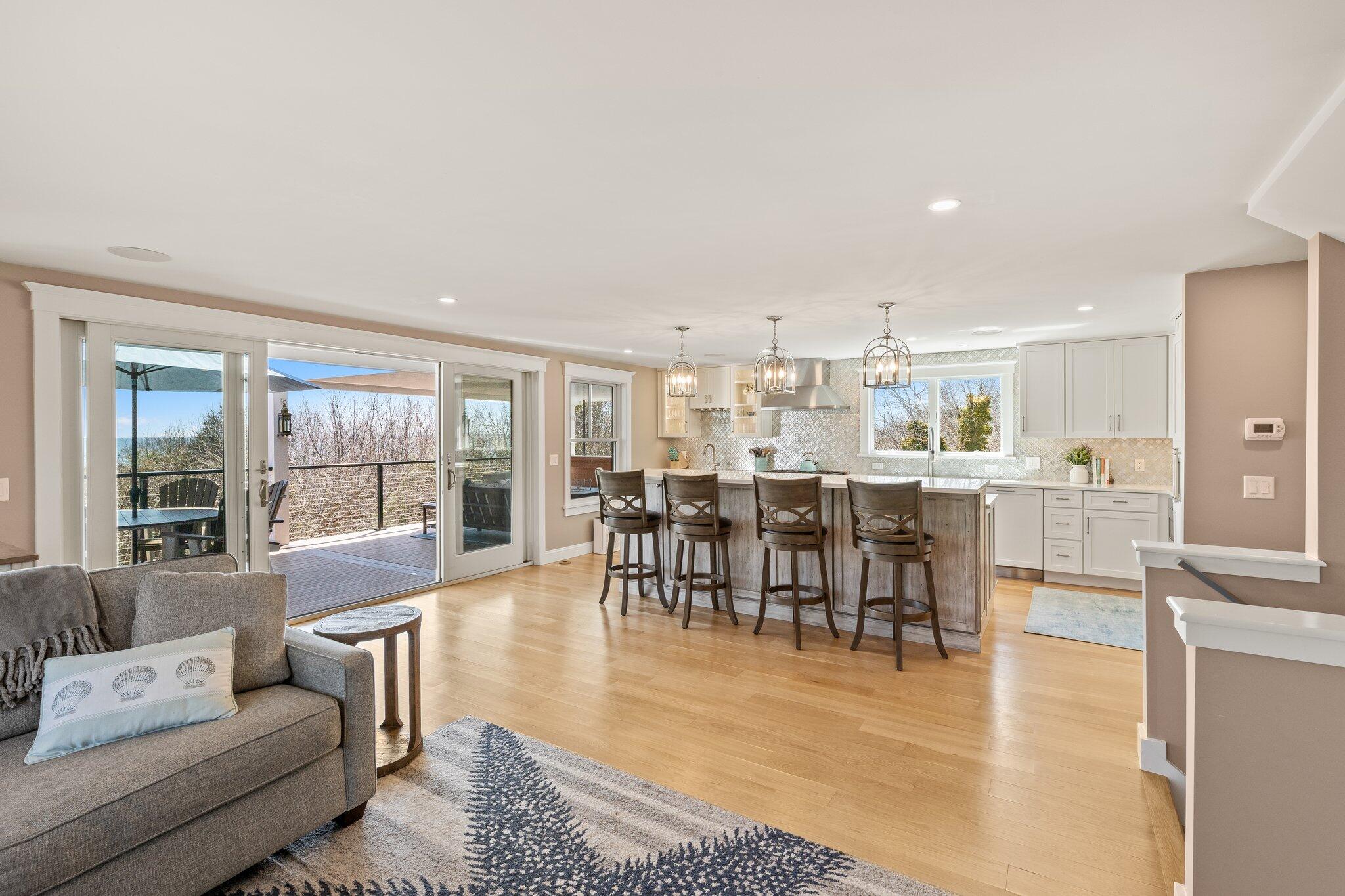 87 Oyster Pond Road Falmouth, MA 02540 - Photo 14 of 105 a living room with furniture a large window and kitchen view