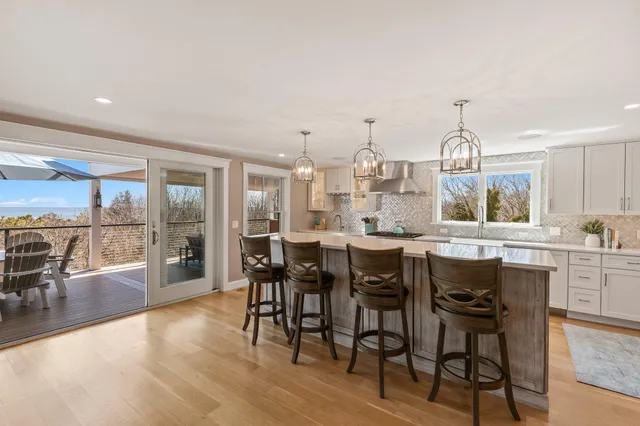 a bathroom with a sink double vanity mirror and a bathtub next to a window