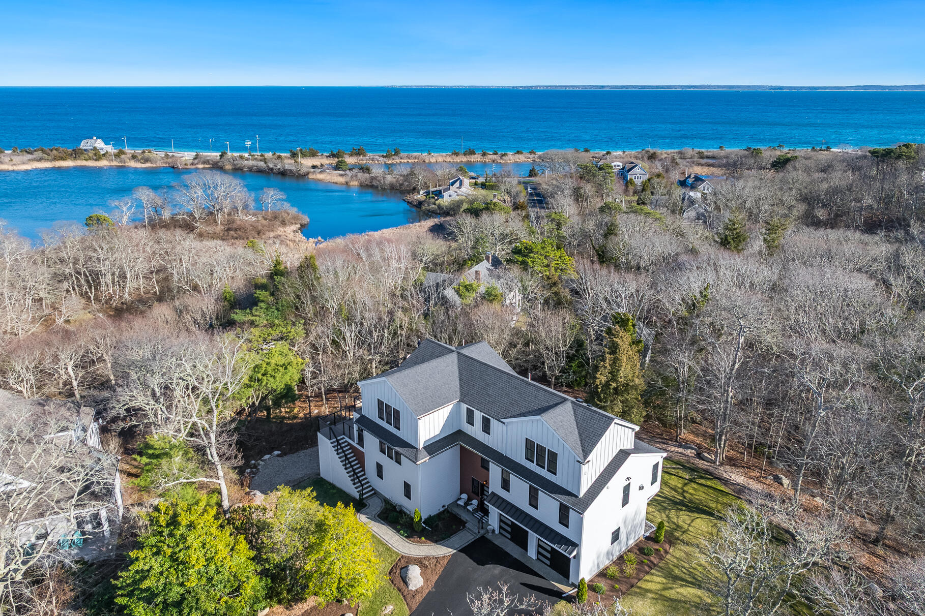 87 Oyster Pond Road Falmouth, MA 02540 - Photo 2 of 105 an aerial view of a house with a lake view