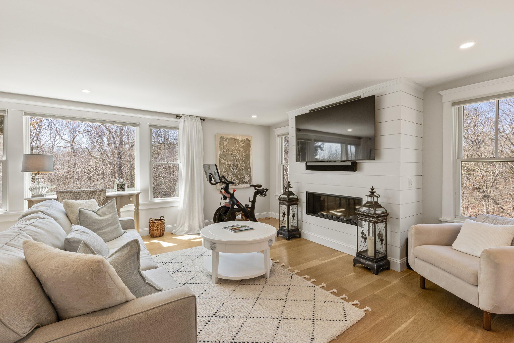 87 Oyster Pond Road Falmouth, MA 02540 - Photo 27 of 105 a living room with furniture a flat screen tv and a large window