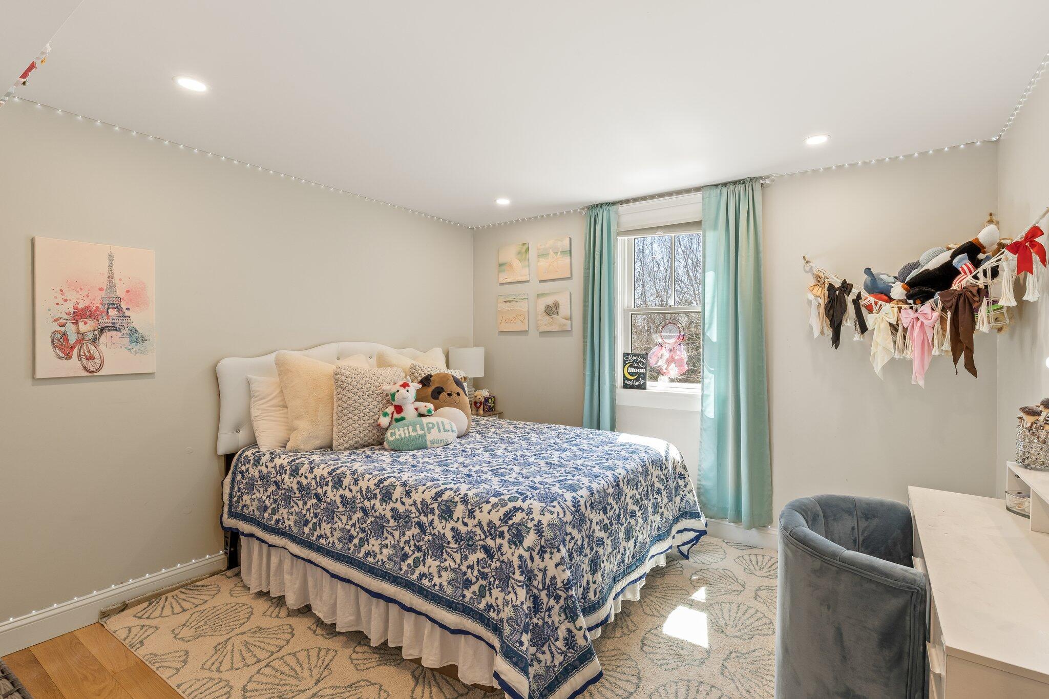 87 Oyster Pond Road Falmouth, MA 02540 - Photo 41 of 105 a bedroom with a large bed and a couch