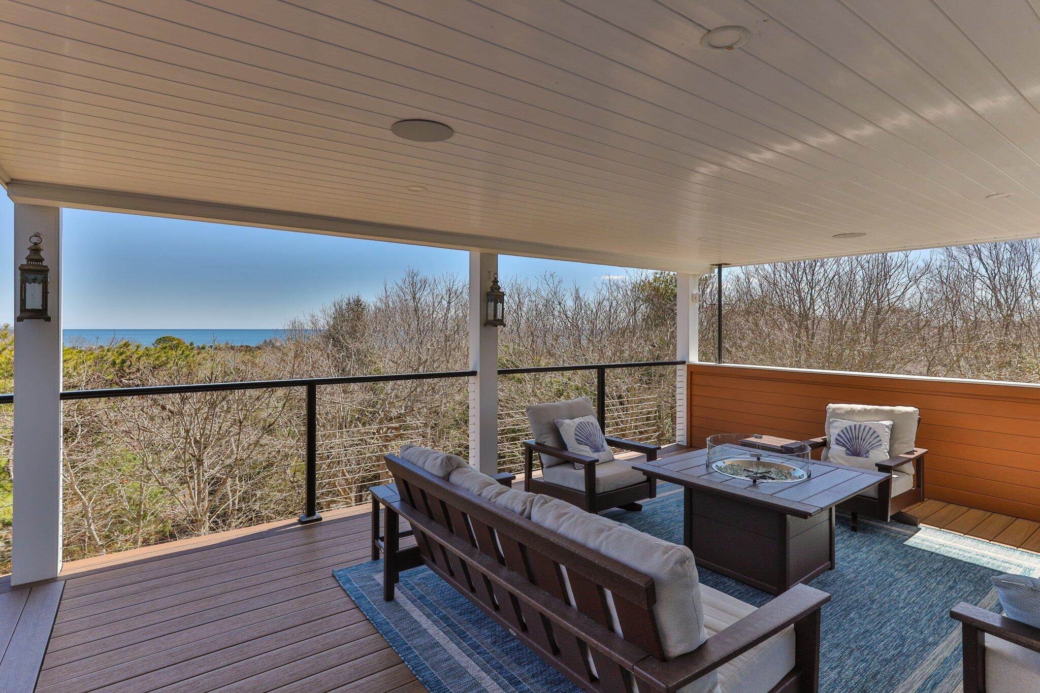 87 Oyster Pond Road Falmouth, MA 02540 - Photo 56 of 105 a view of a balcony with wooden floor and outdoor seating