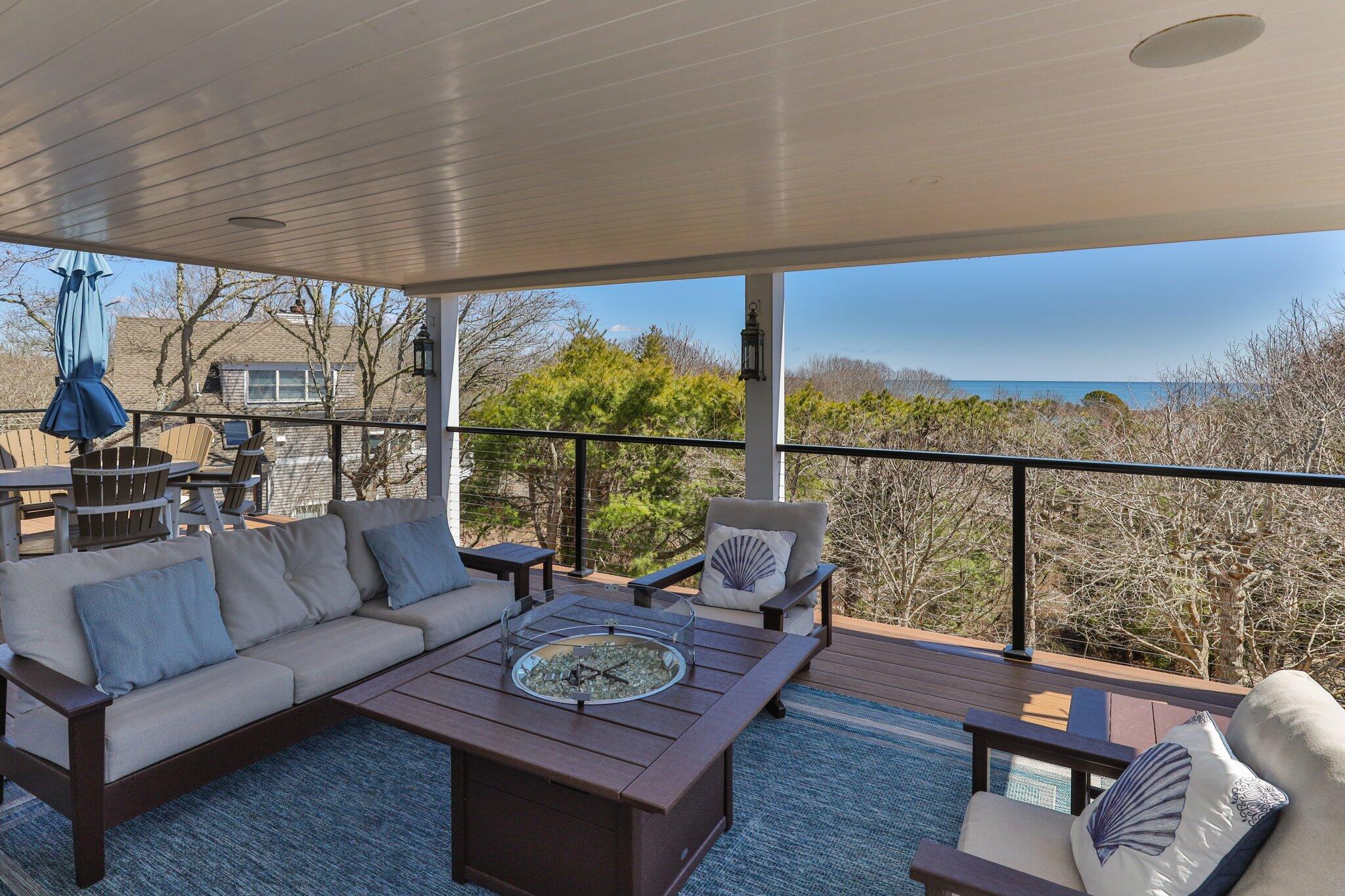 87 Oyster Pond Road Falmouth, MA 02540 - Photo 58 of 105 a living room with furniture and a floor to ceiling window