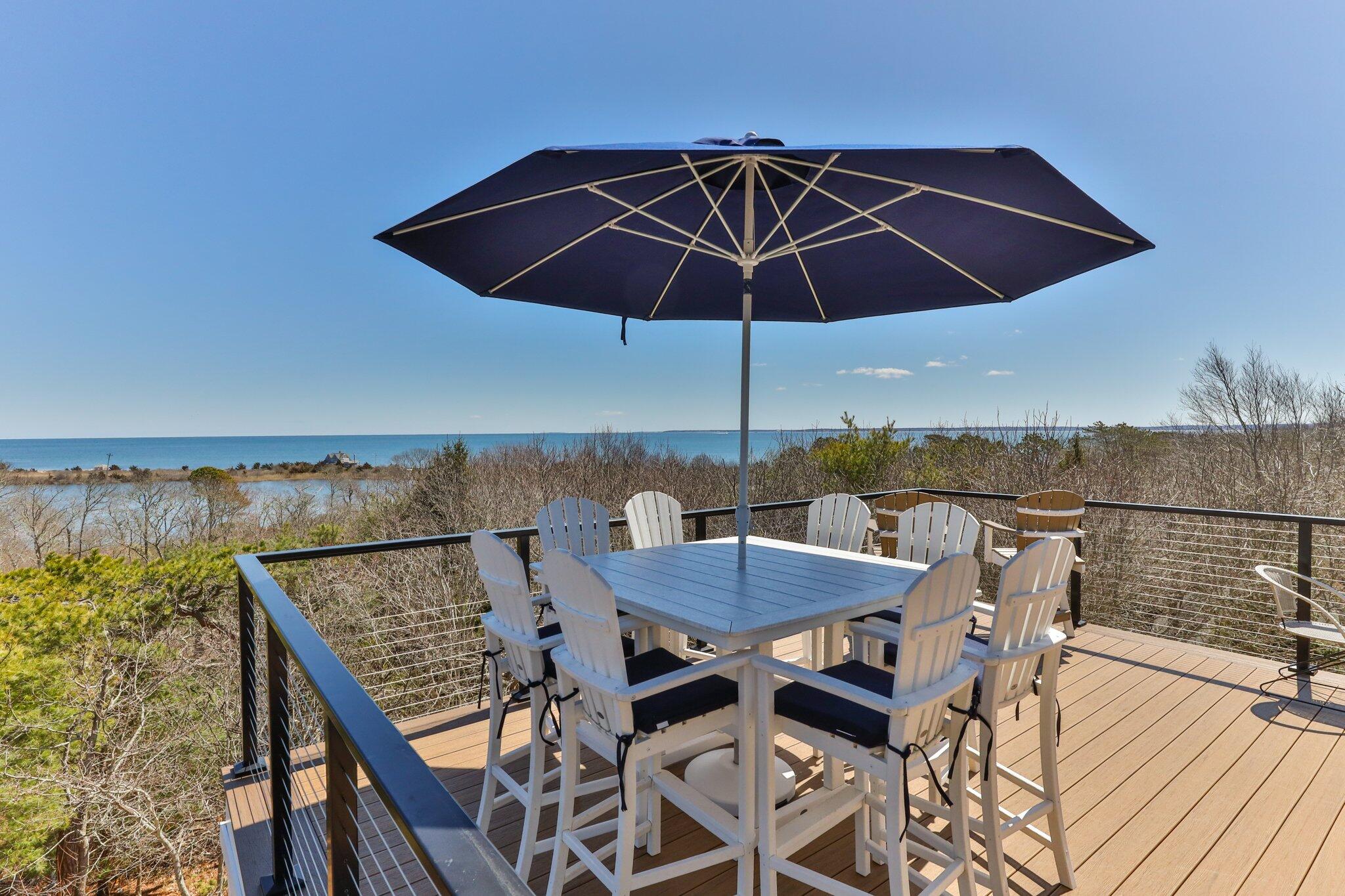 87 Oyster Pond Road Falmouth, MA 02540 - Photo 59 of 105 an outdoor space with furniture and umbrella