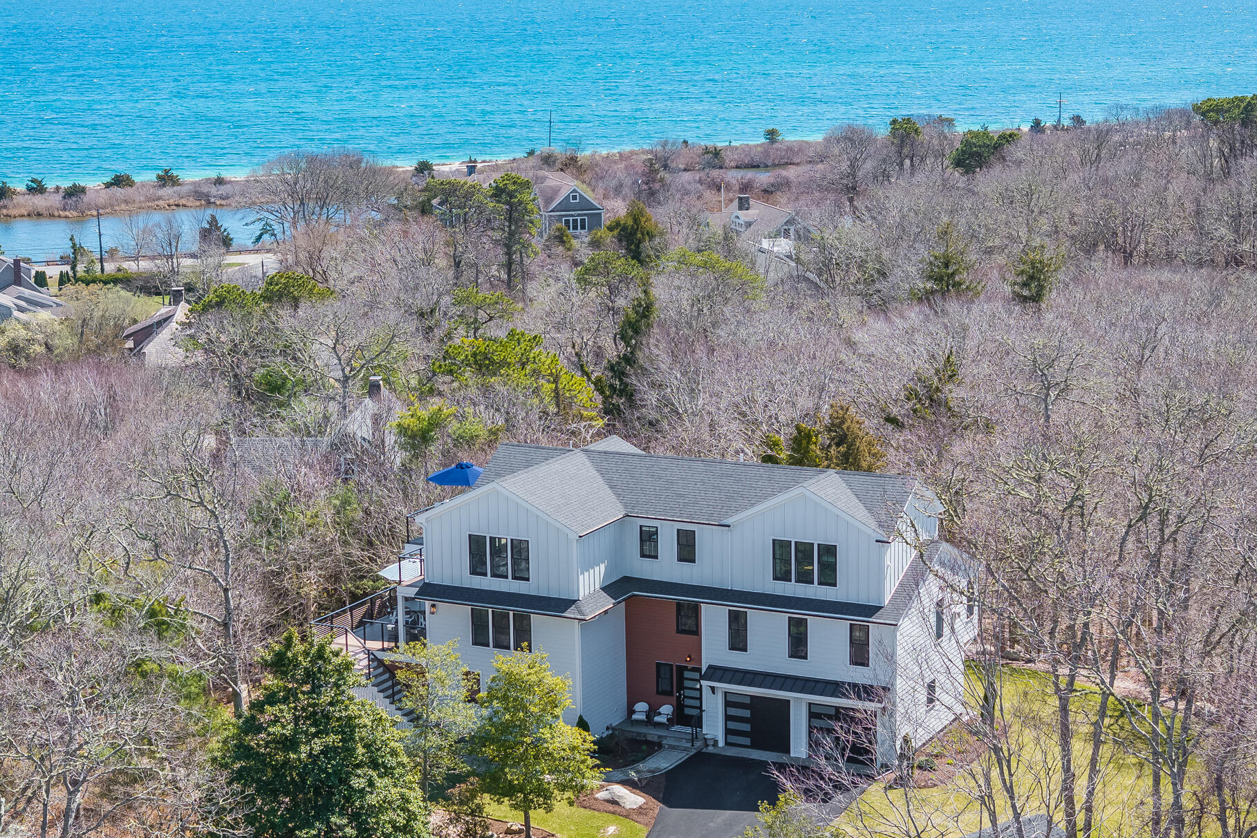 87 Oyster Pond Road Falmouth, MA 02540 - Photo 98 of 105 a aerial view of a house next to a yard