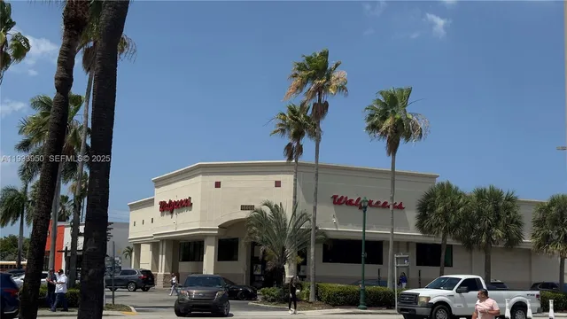 a front view of a building with palm trees