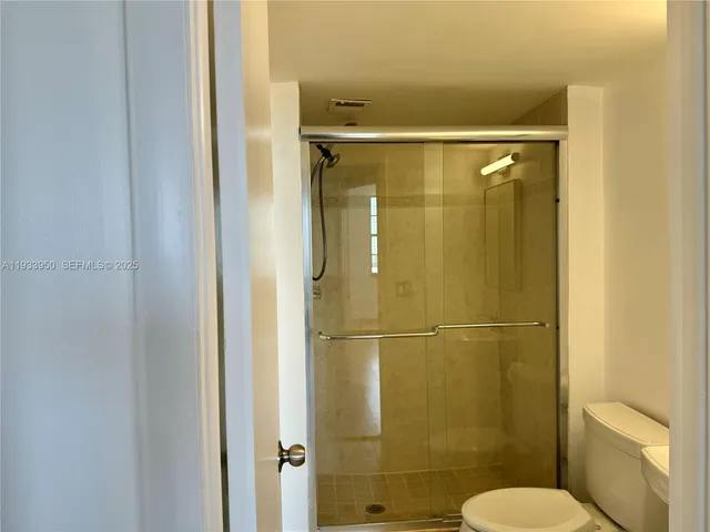 a bathroom with a shower and toilet