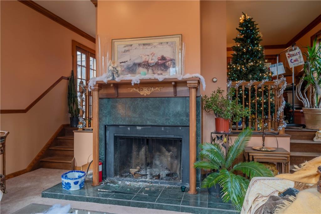 280 Ferry Road Sewickley, PA 15143 - Photo 9 of 21 a living room with a fireplace and potted plants