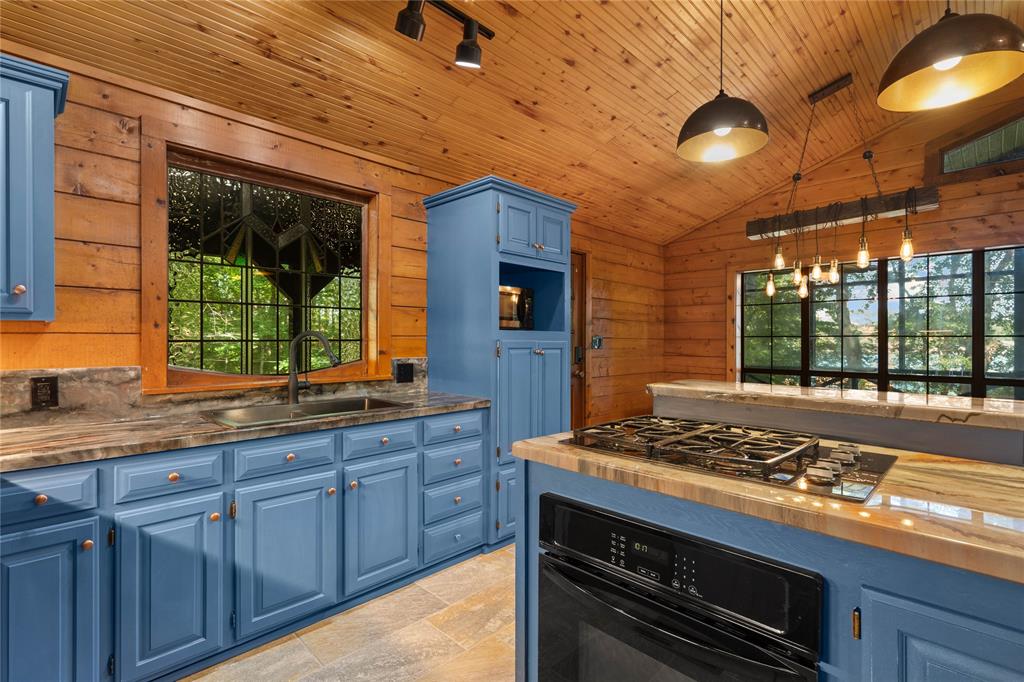 295 Coleman Road Homer, LA 71040 - Photo 14 of 38 a kitchen with wooden cabinets and a stove top oven