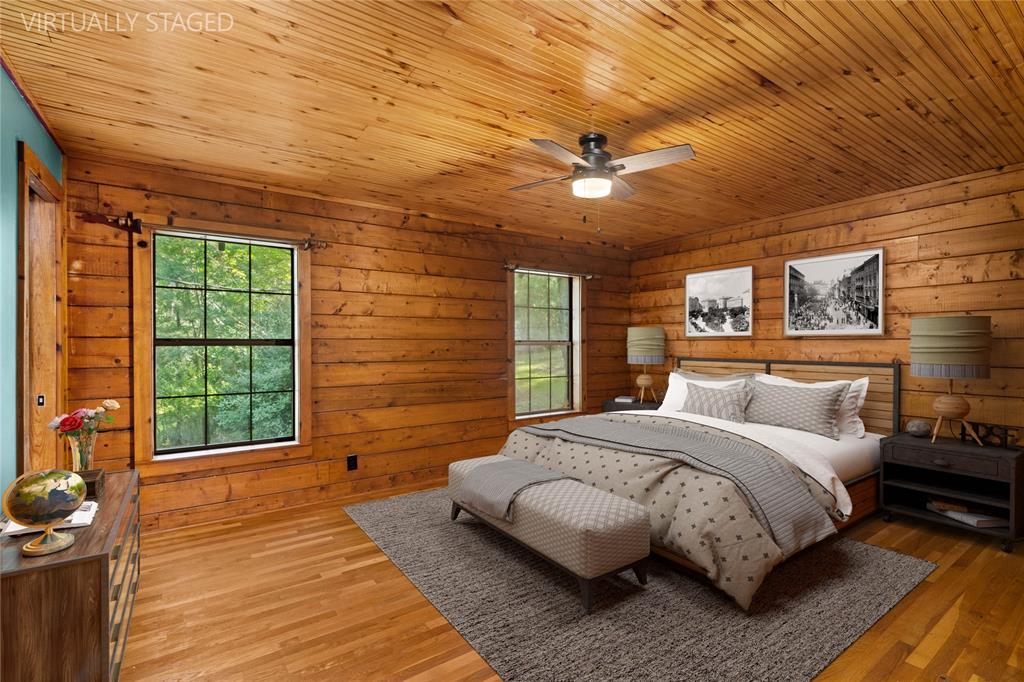 295 Coleman Road Homer, LA 71040 - Photo 16 of 38 a bedroom with a large bed mirror and a large window