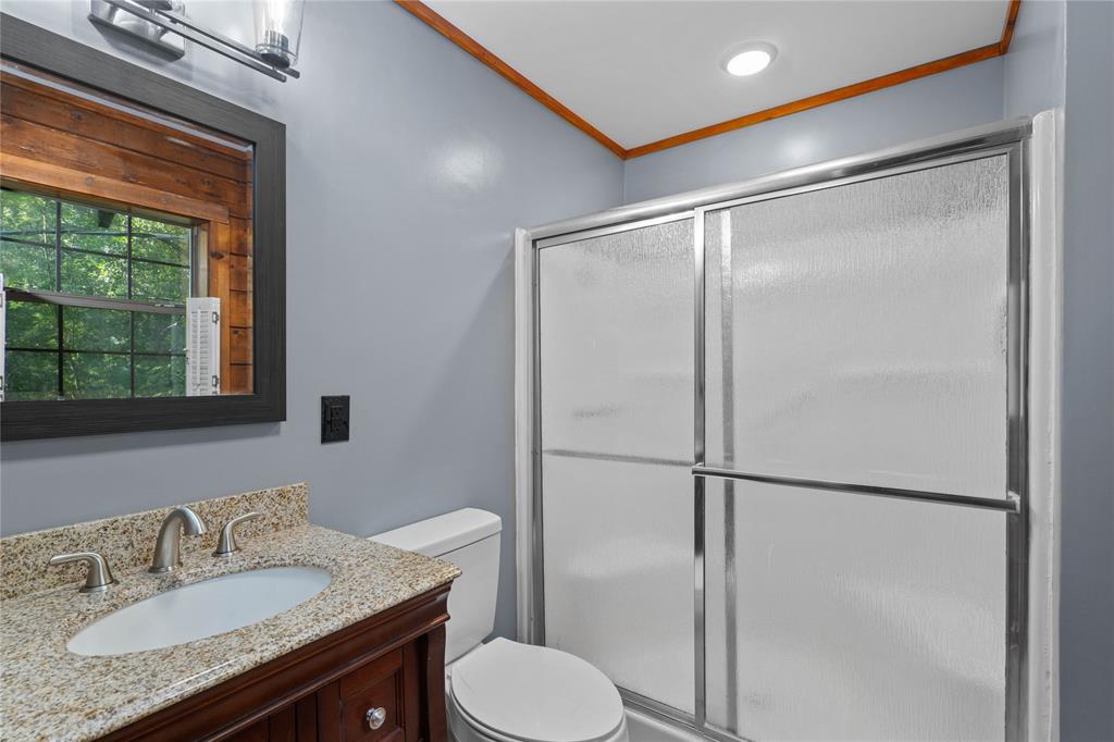 295 Coleman Road Homer, LA 71040 - Photo 18 of 38 a bathroom with a granite countertop sink toilet and shower