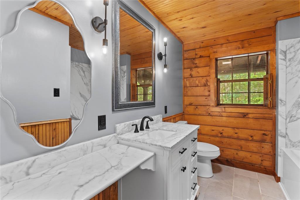 295 Coleman Road Homer, LA 71040 - Photo 21 of 38 a bathroom with a granite countertop sink and a mirror