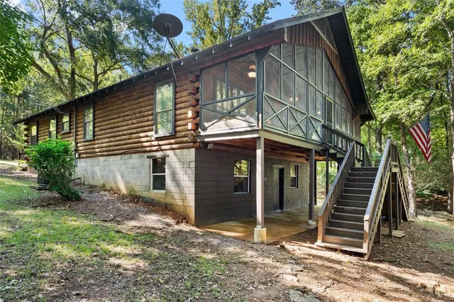 a view of a house with a small wooden fence