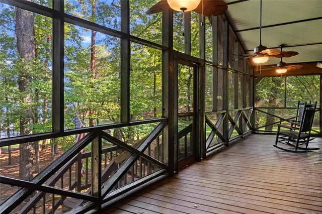 a view of a balcony with chairs and wooden floor
