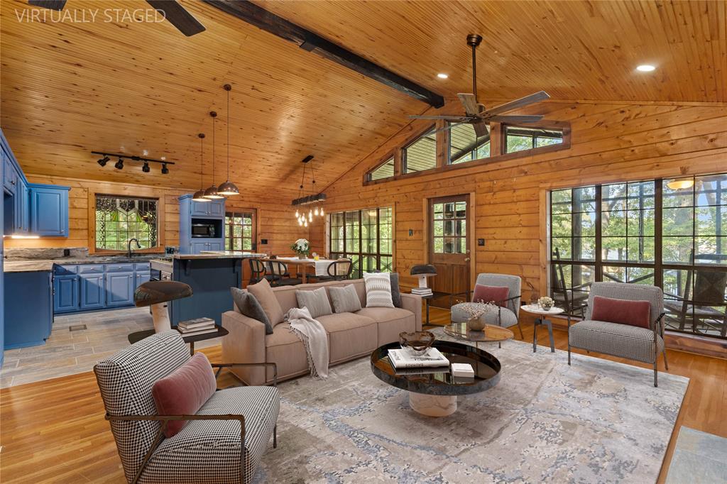 295 Coleman Road Homer, LA 71040 - Photo 7 of 38 a living room with furniture a rug kitchen view and a chandelier