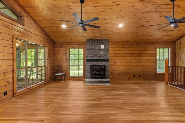a view of an empty room with a fireplace and a window