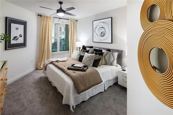 a bedroom with bed and a chandelier