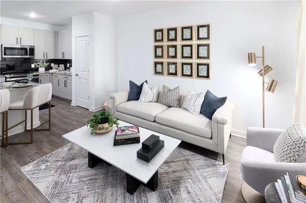 a living room with furniture a rug and a bookshelf