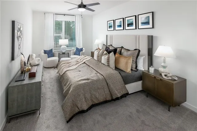 a bedroom with bed couch and window