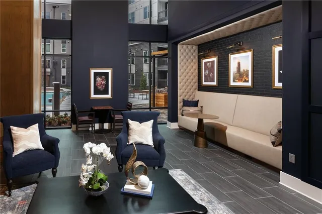 a living room with furniture and a potted plant