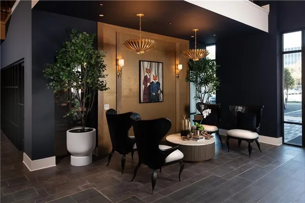 a lobby with furniture and potted plant