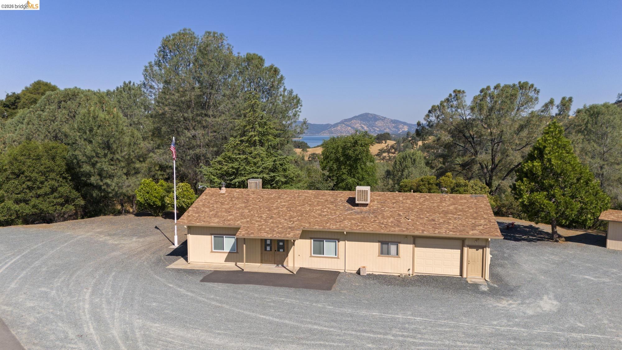 8400 Old Melones Road Jamestown, CA 95327 - Photo 17 of 23 a view of a patio with table and chairs with wooden floor and fence
