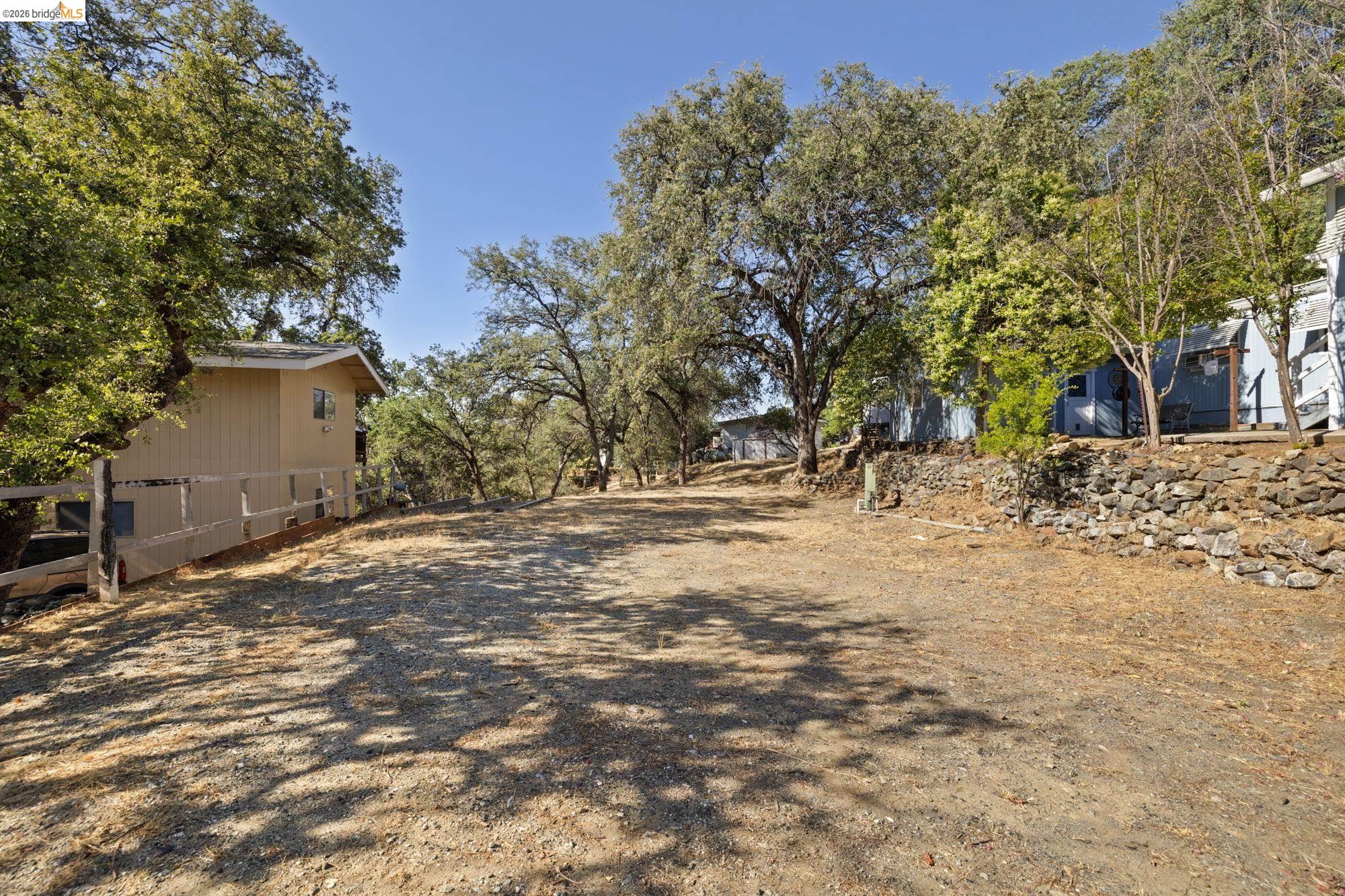 8400 Old Melones Road Jamestown, CA 95327 - Photo 2 of 23 a view of yard covered with trees
