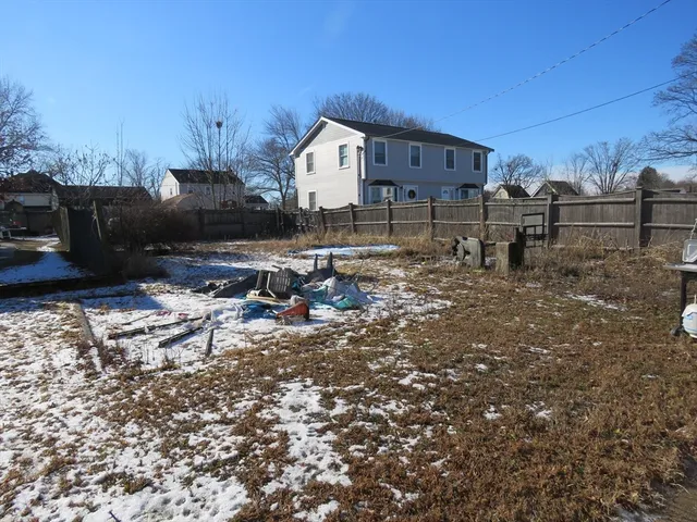 a view of a house with backyard and chair