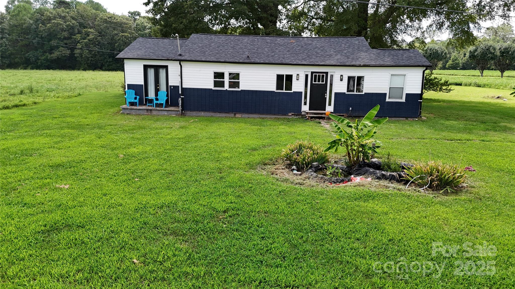 a view of a house with a yard and sitting area