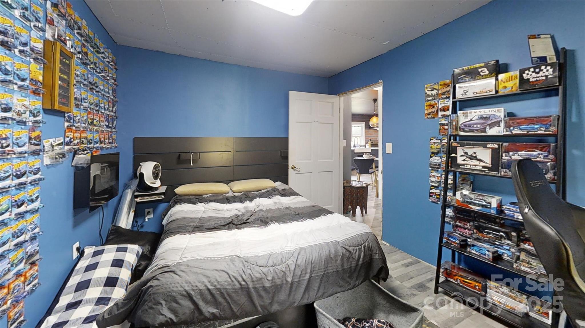 751 Northbrook III School Road Vale, NC 28168 - Photo 8 of 11 a bedroom with a bed and a book shelf