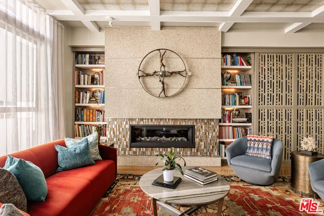 a living room with furniture a rug and a wall painting