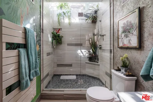 a bathroom with a toilet and a shower