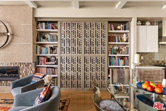 a living room with fireplace furniture and a book shelf