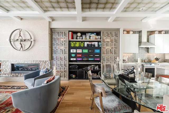 a living room with furniture a rug and a clock