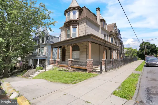 a front view of a house with a yard table and chairs