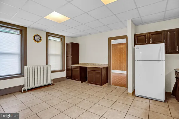 a living room with a refrigerator and a refrigerator