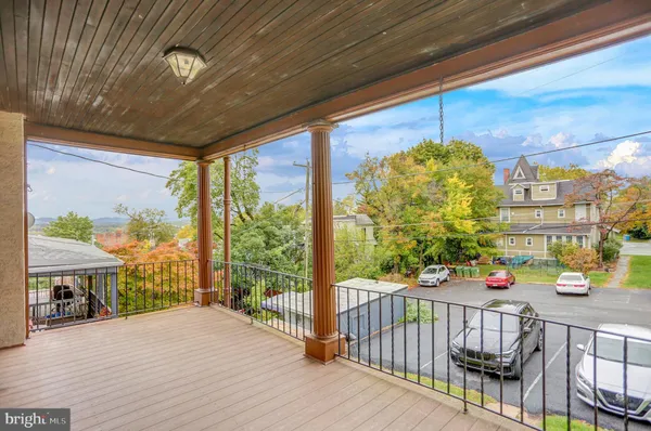 a view of a porch with wooden floor