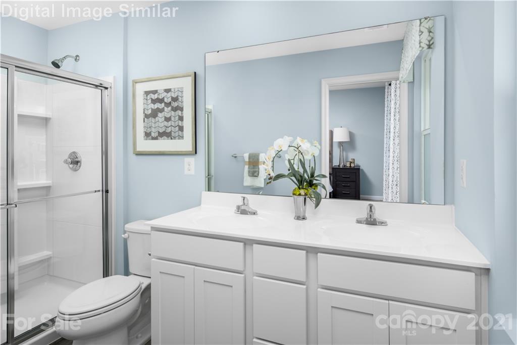 5125 Tinker Field Road, Unit 2019 Charlotte, NC 28215 - Photo 6 of 10 a bathroom with a sink toilet and shower