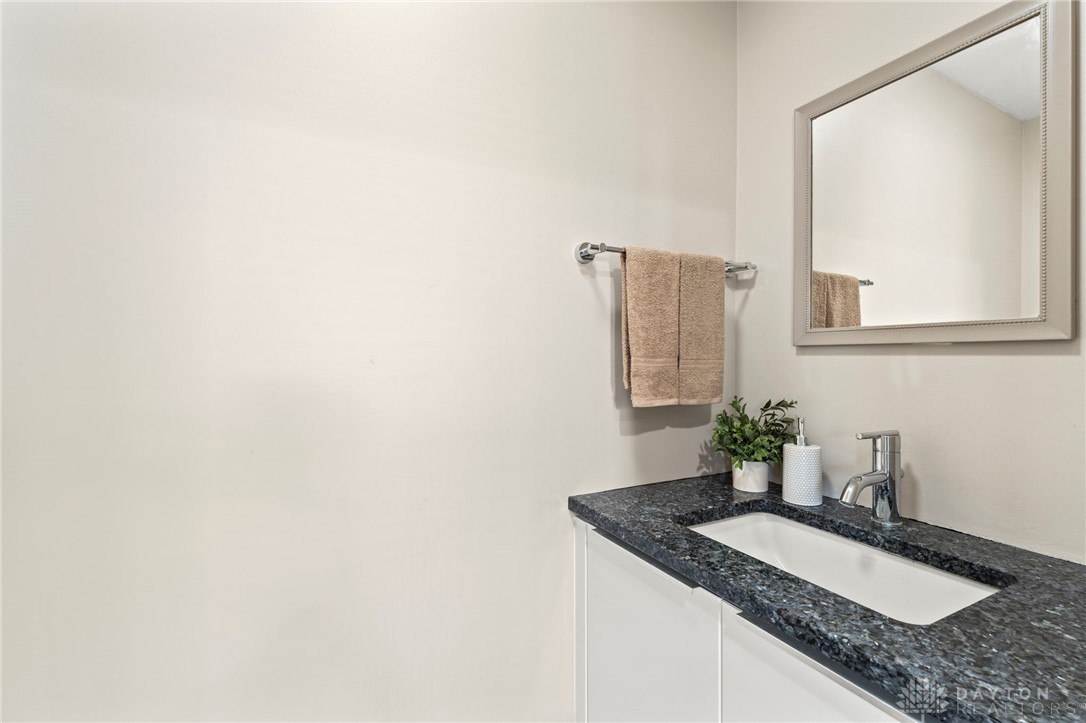 2247 East Whipp Road Dayton, OH 45440 - Photo 39 of 52 This clean and functional bathroom features a sleek vanity with a modern sink and a convenient mirror.