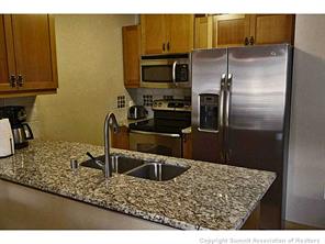 910 Copper Road, Unit 603 Copper Mountain, CO 80443 - Photo 8 of 20 a kitchen with a sink refrigerator and microwave