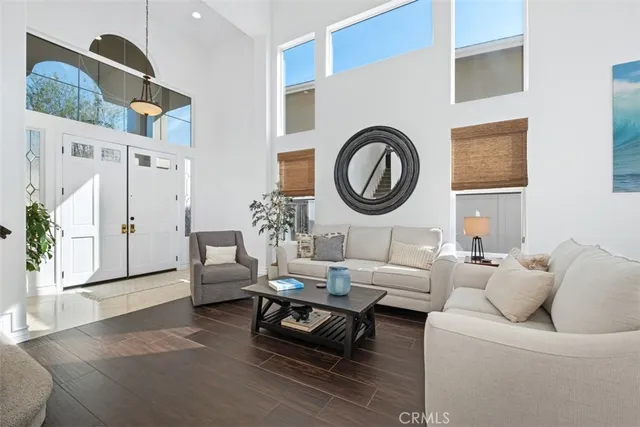 a living room with furniture a rug and a large window