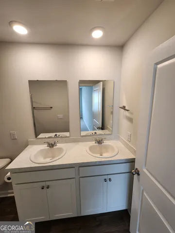 a bathroom with a double vanity sink and a mirror