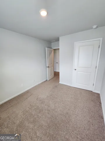 a view of an empty room and a window