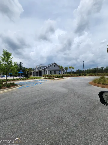a view of a city street with a car parked on the road
