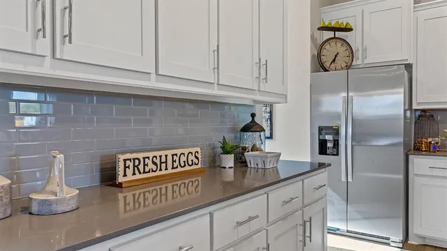 a kitchen with stainless steel appliances granite countertop a stove refrigerator and cabinets
