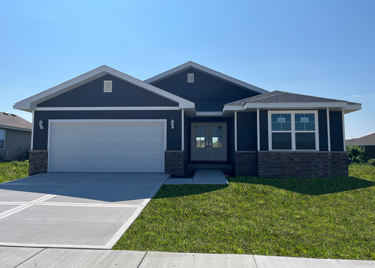 5541 Old Manor Road Bourbonnais, IL 60914 - Photo 1 of 9 a front view of a house with a yard and garage