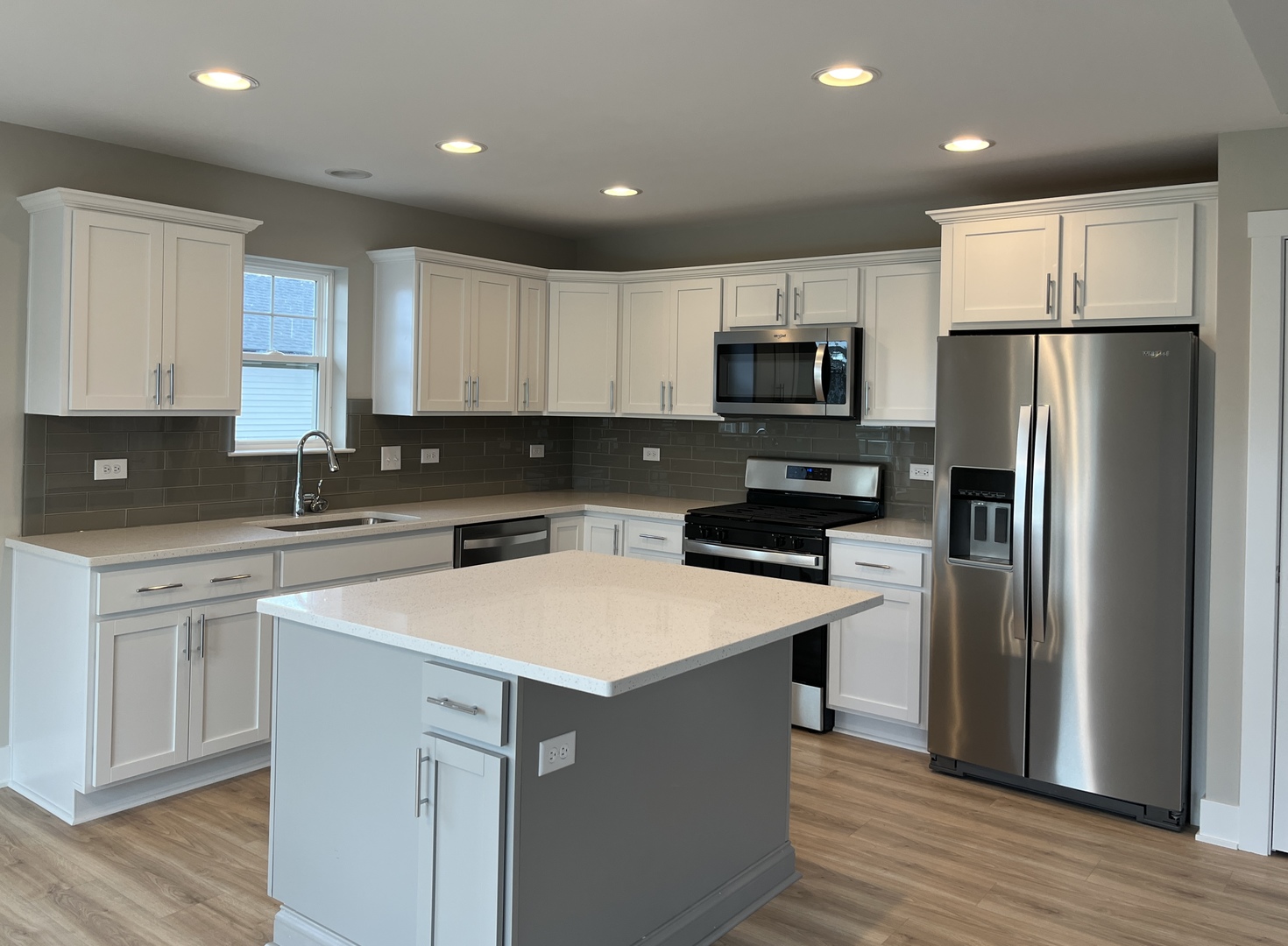 5541 Old Manor Road Bourbonnais, IL 60914 - Photo 2 of 9 a kitchen with a refrigerator a stove top oven a sink and cabinets