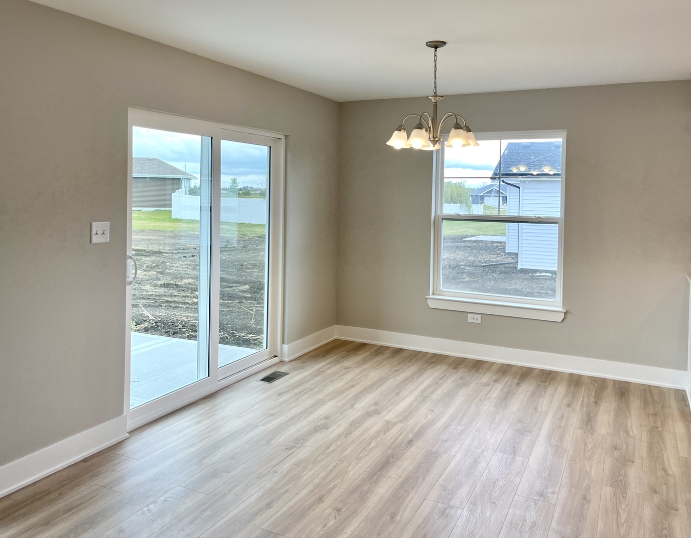 5541 Old Manor Road Bourbonnais, IL 60914 - Photo 3 of 9 wooden floor in an empty room with a window